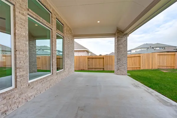 a view of a big room with a big yard and large tree