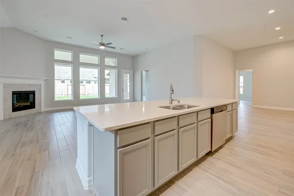 a spacious bathroom with double vanity and a large mirror