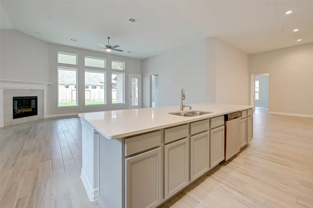 a spacious bathroom with double vanity and a large mirror