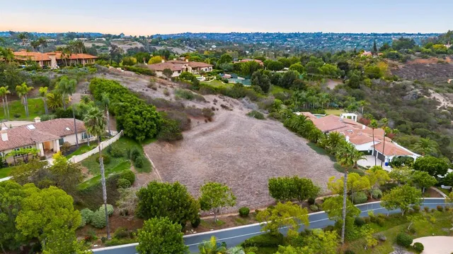an aerial view of residential houses with outdoor space and street view