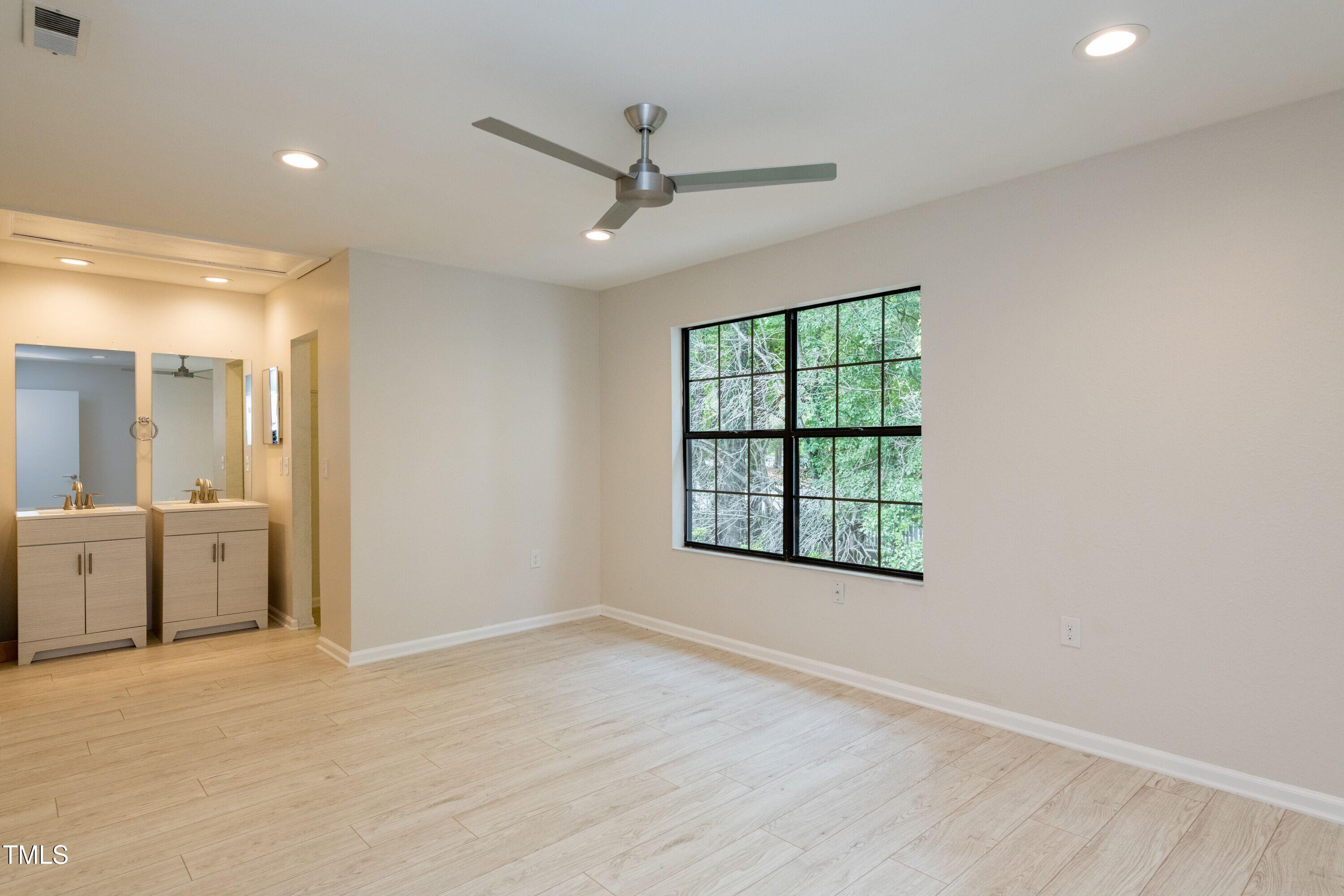 2434 Condor Court Raleigh, NC 27615 - Photo 14 of 21 an empty room with windows and cabinet