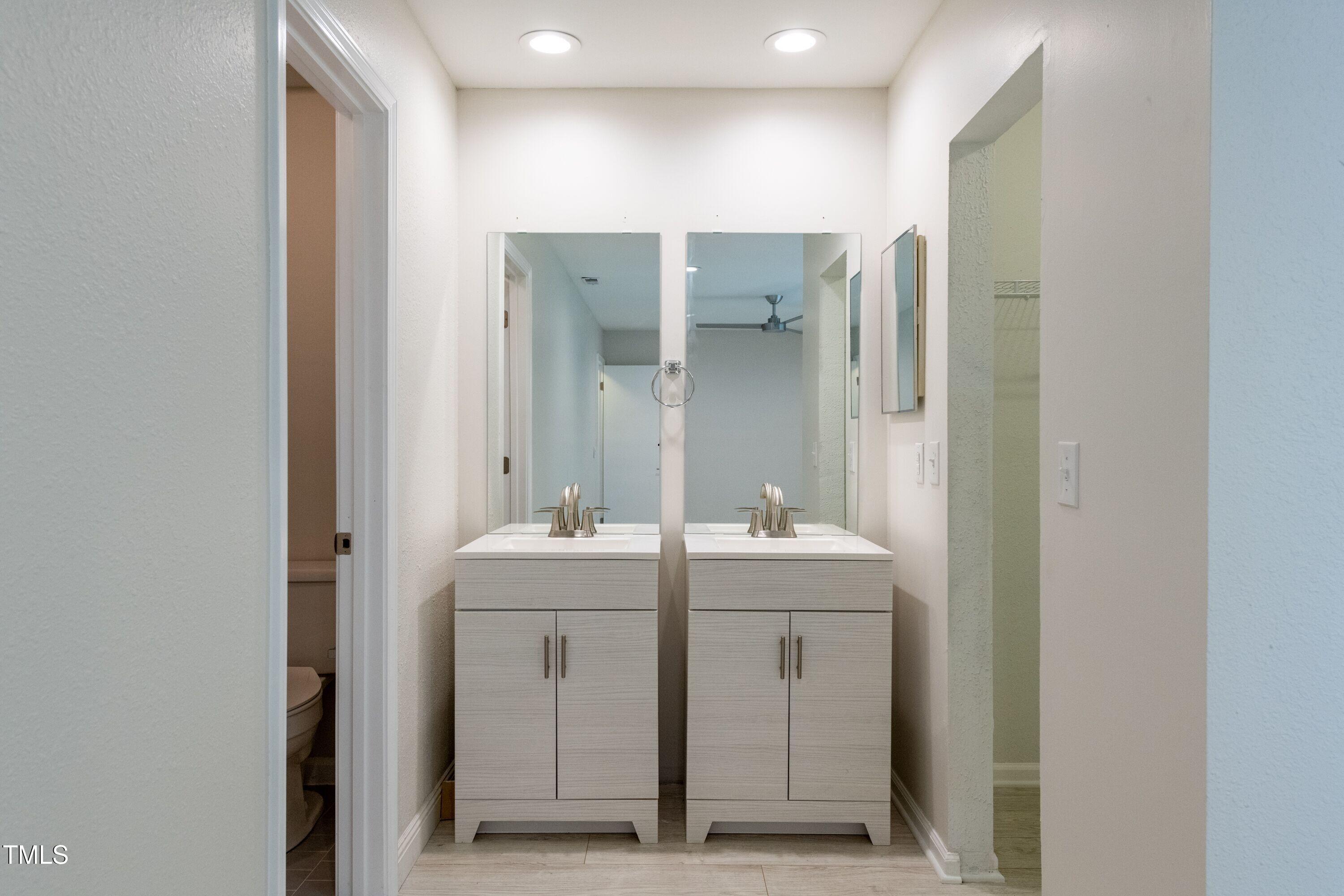 2434 Condor Court Raleigh, NC 27615 - Photo 15 of 21 a bathroom with double sink and mirror