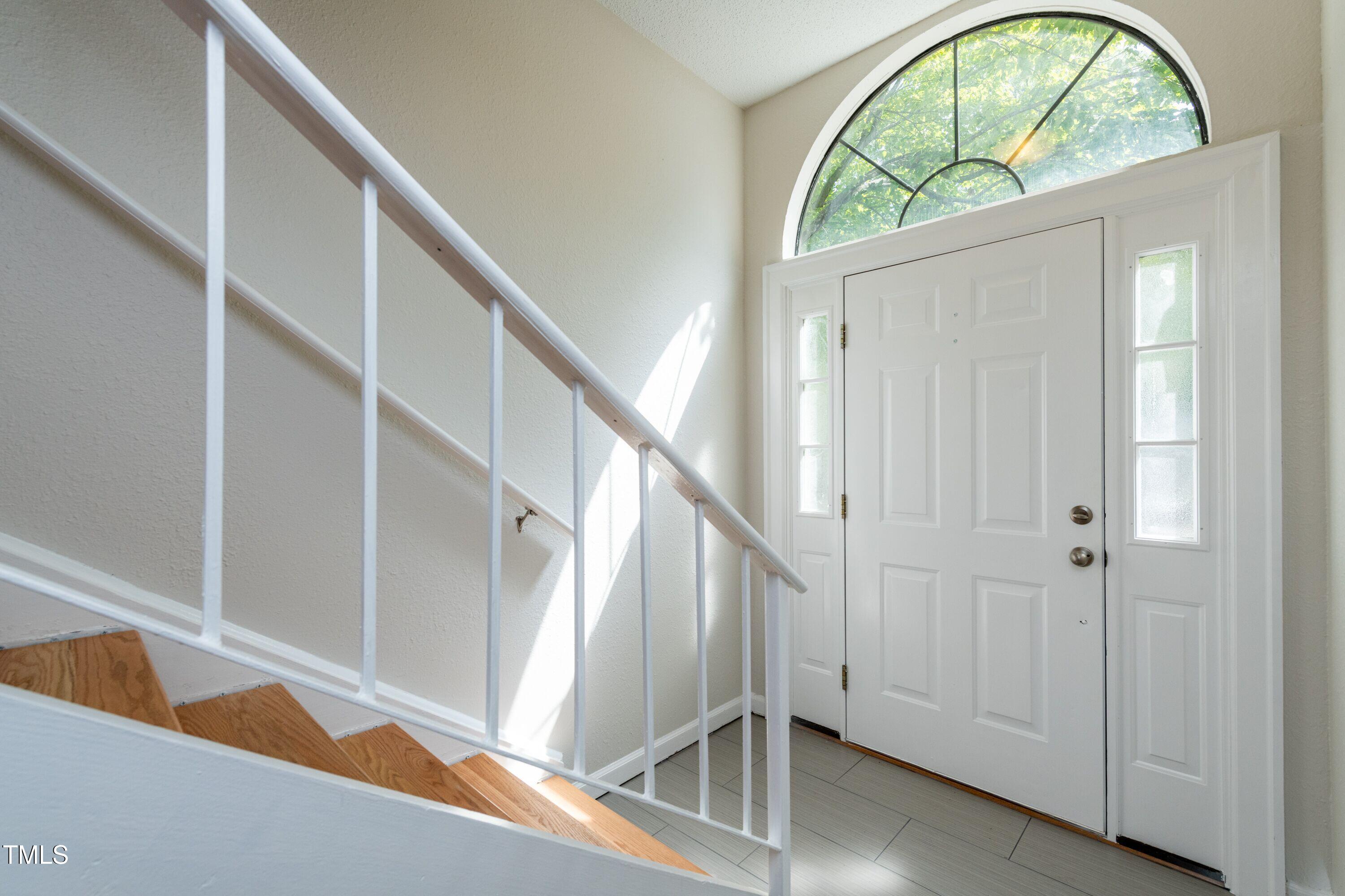2434 Condor Court Raleigh, NC 27615 - Photo 4 of 21 a view of staircase with white walls and a window
