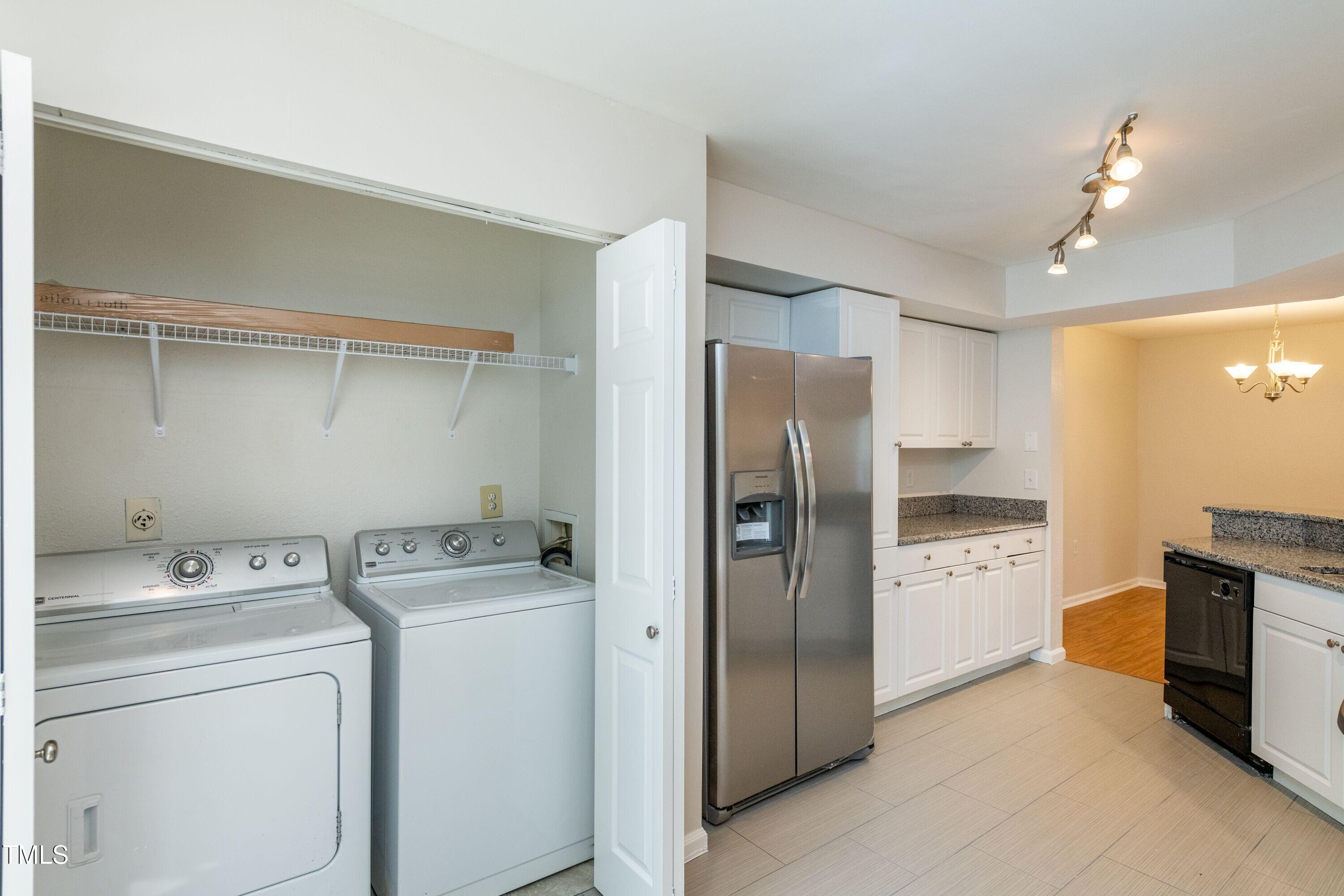 2434 Condor Court Raleigh, NC 27615 - Photo 7 of 21 a kitchen with refrigerator and washer dryer