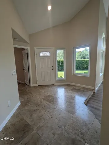 an empty room with windows and entrance