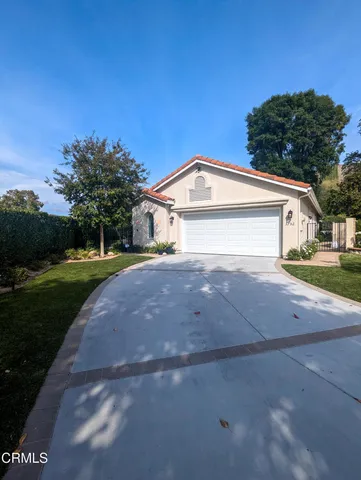 a view of house with outdoor space and garden