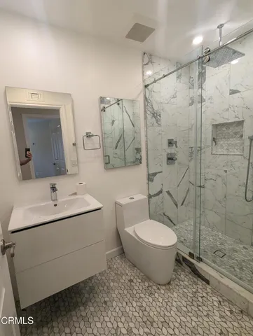 a bathroom with a toilet sink and shower
