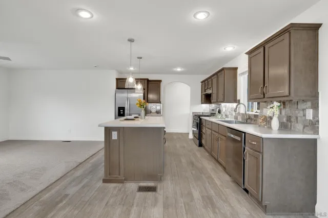 a kitchen with a refrigerator and a sink