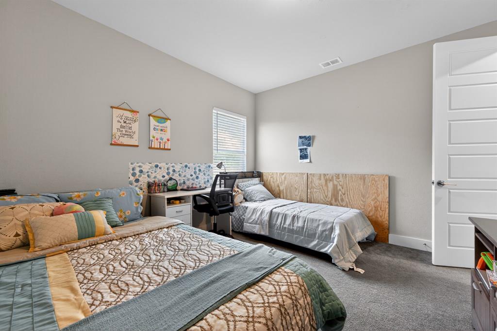 411 West Harwood Road Euless, TX 76039 - Photo 25 of 29 The property features a room with light grey walls, carpeted flooring, and a white paneled door