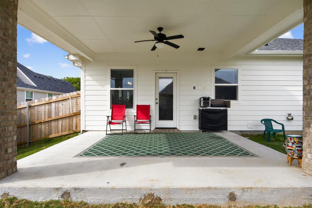 411 West Harwood Road Euless, TX 76039 - Photo 28 of 29 The property features a covered concrete patio with an outdoor ceiling fan