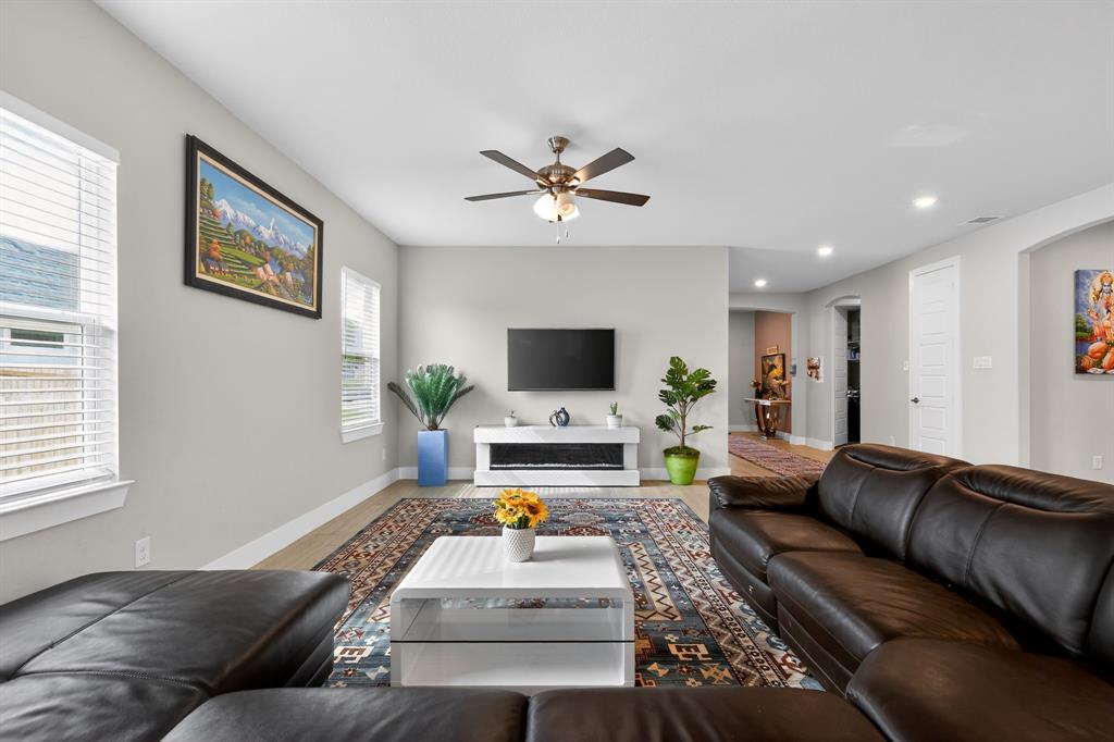 411 West Harwood Road Euless, TX 76039 - Photo 5 of 29 Spacious living area featuring light-toned walls, recessed lighting, and a ceiling fan