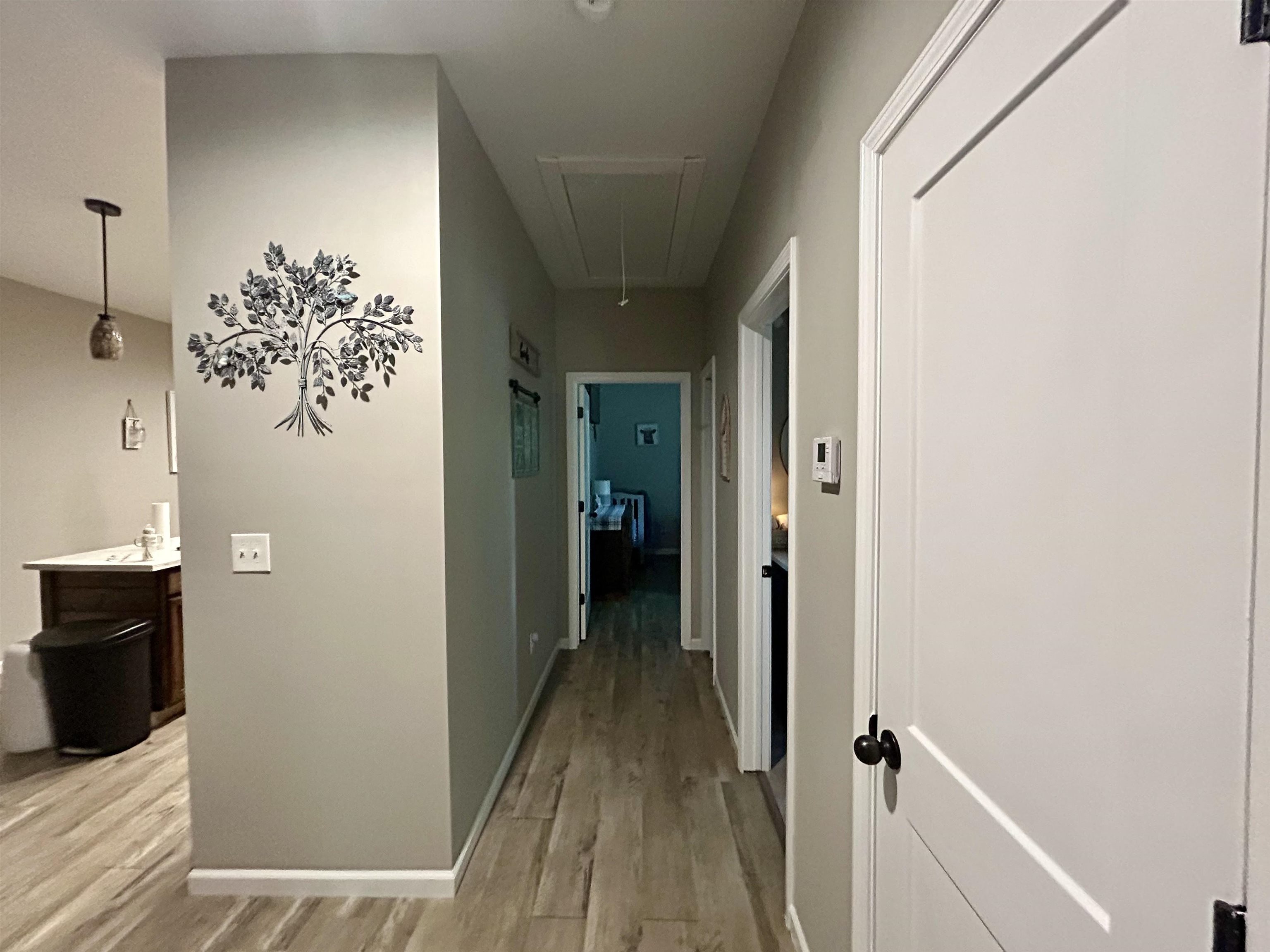 Hallway featuring light wood-style floors and baseboards