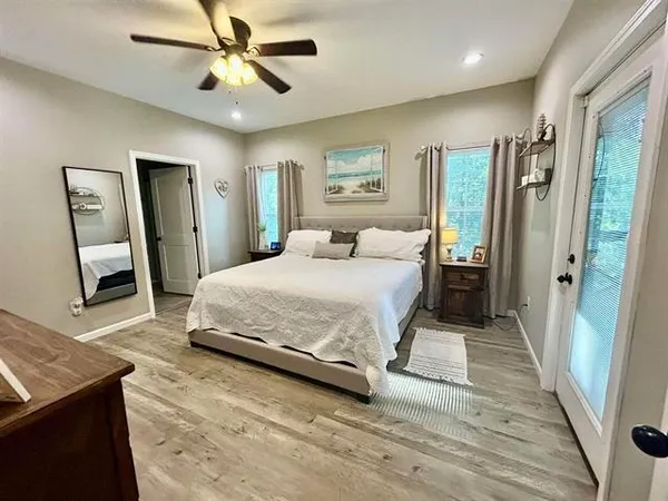 a bedroom with a bed and flat screen tv