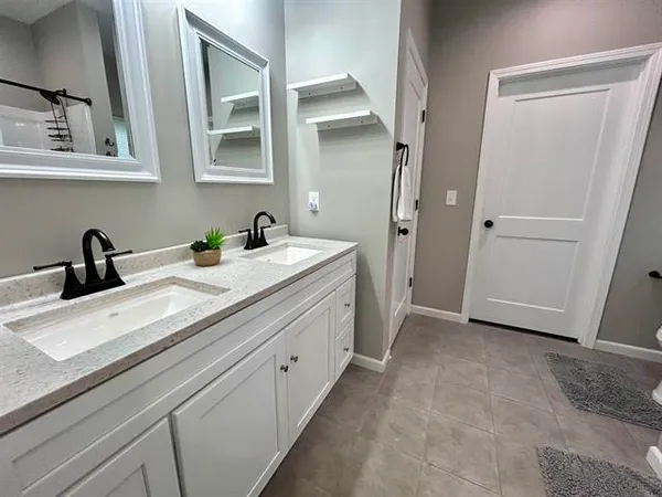 a bathroom with a toilet sink vanity and mirror