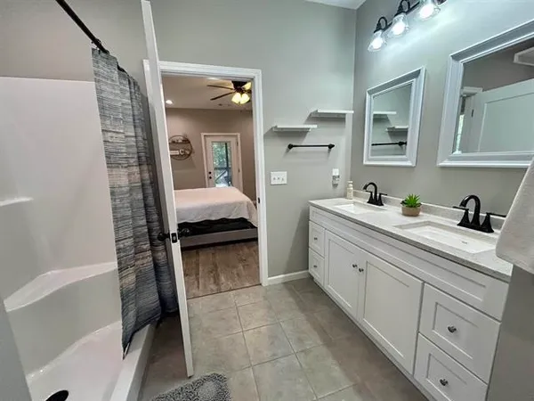 a bathroom with a shower and a sink