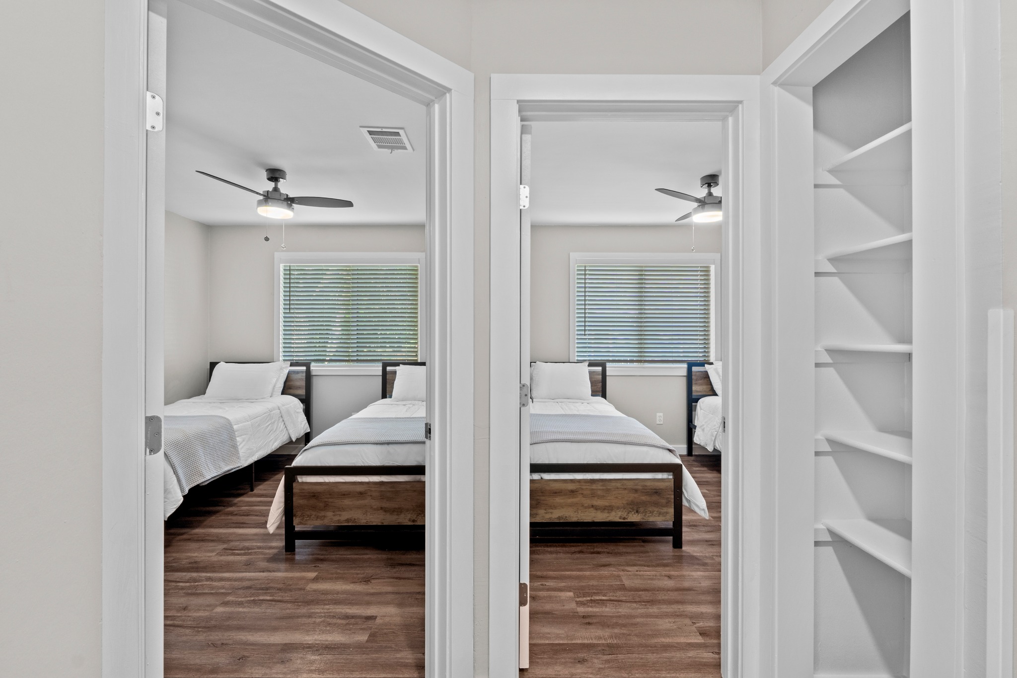 11811 Rotherham Drive Austin, TX 78754 - Photo 24 of 37 Two bright, functional bedrooms await through these doorways, each offering comfortable living with durable flooring.