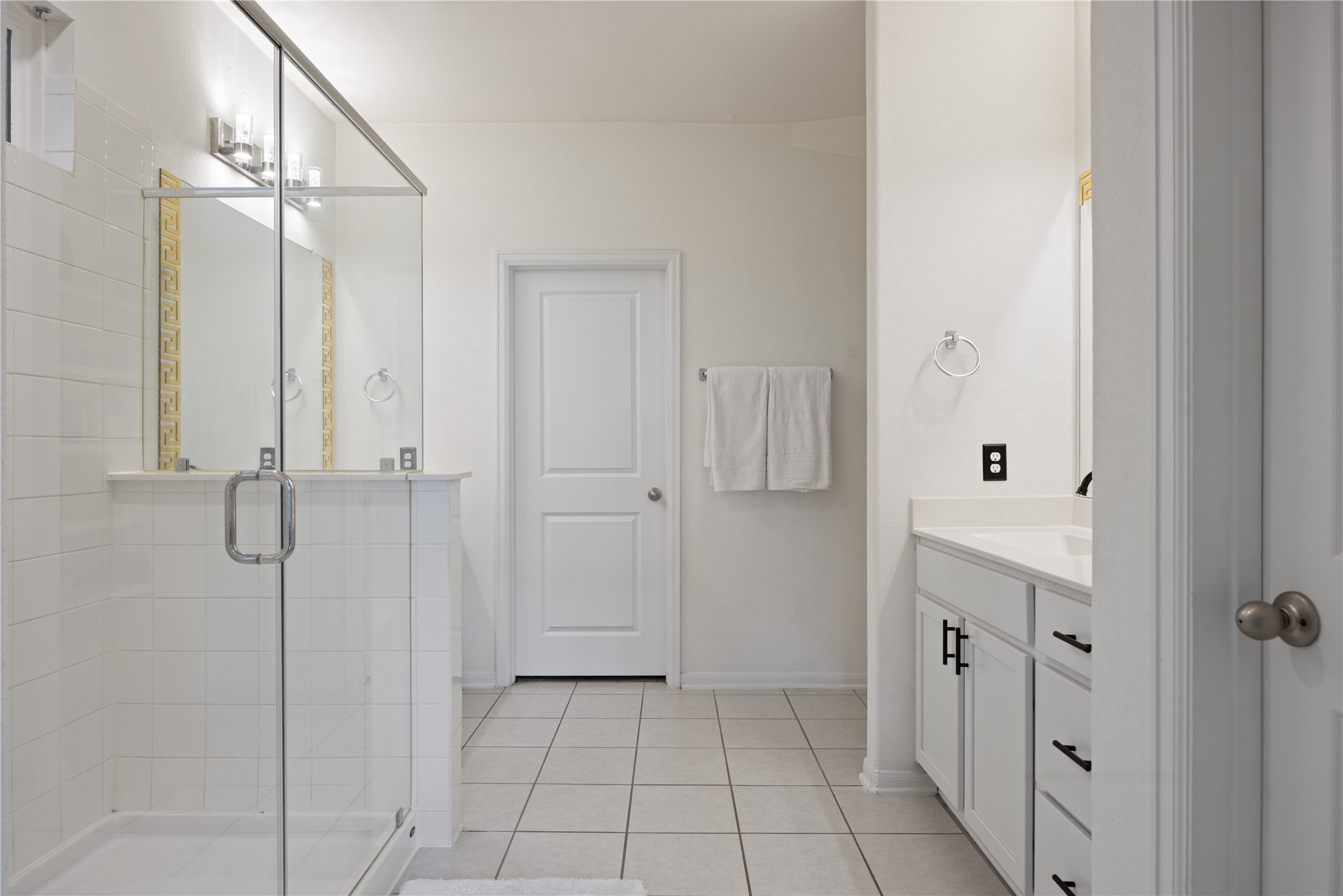 241 Oleander Loop Buda, TX 78610 - Photo 16 of 33 a bathroom with a sink a mirror and shower