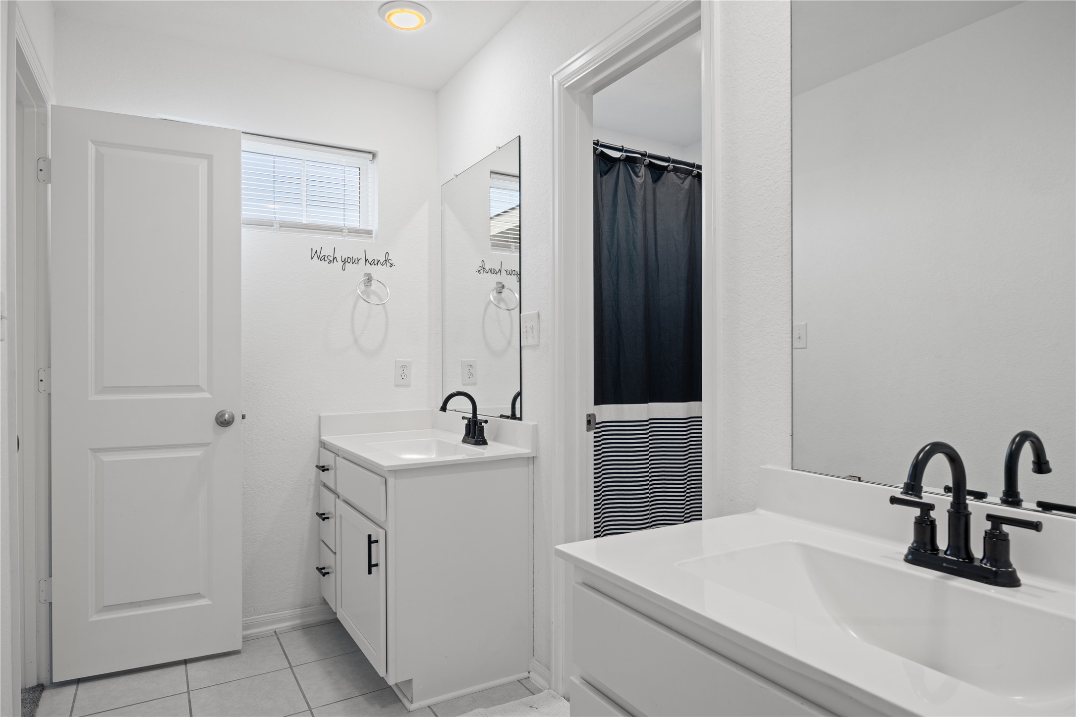 241 Oleander Loop Buda, TX 78610 - Photo 23 of 33 a bathroom with a sink and a mirror
