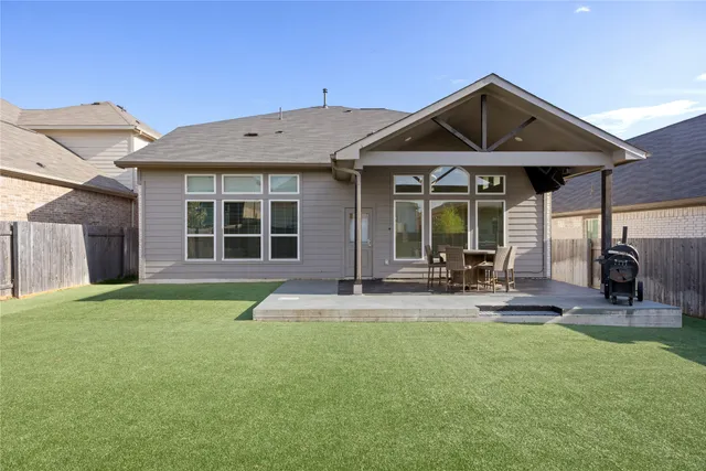 a view of a house with backyard and porch