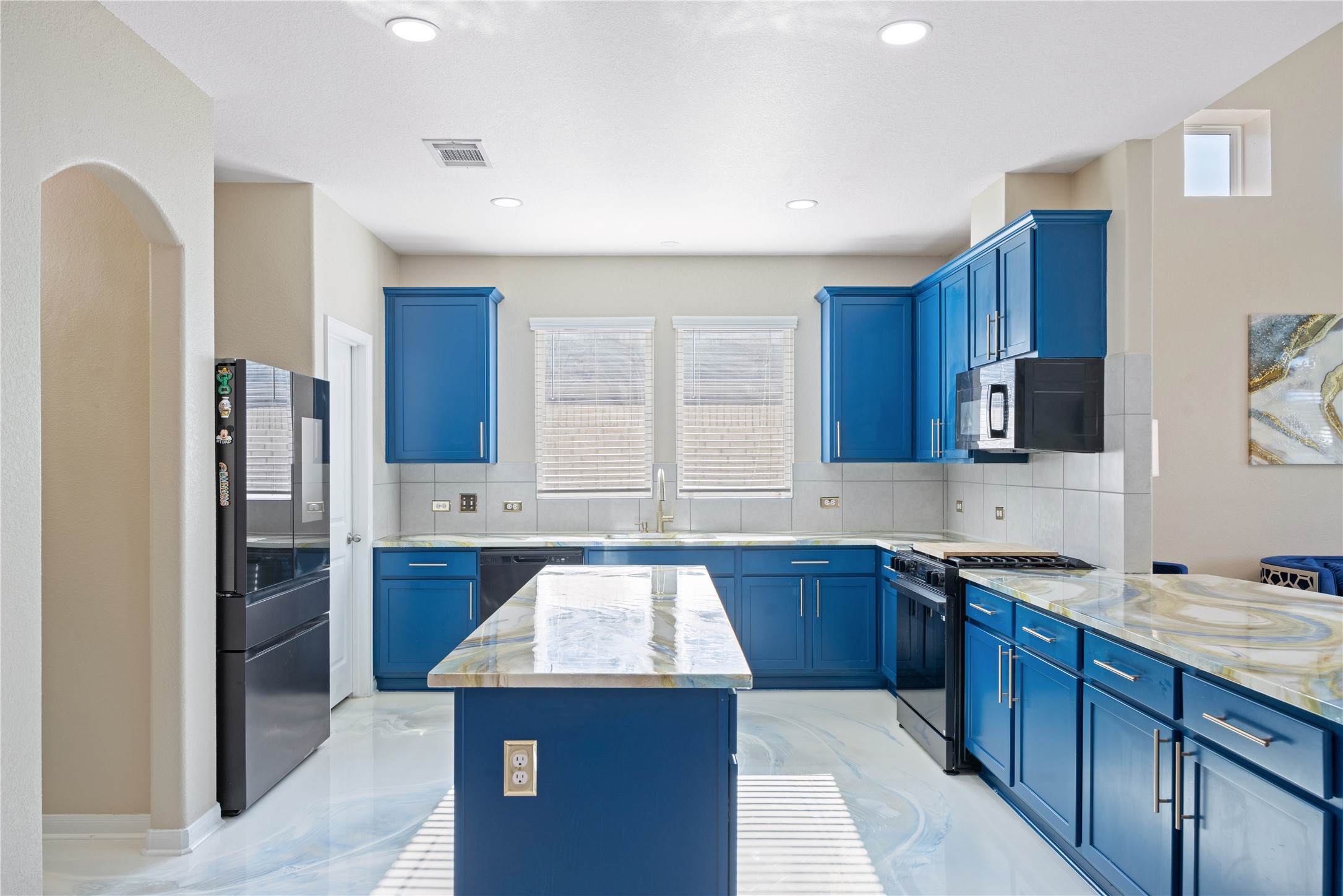 241 Oleander Loop Buda, TX 78610 - Photo 6 of 33 a kitchen with stainless steel appliances granite countertop a sink stove and refrigerator