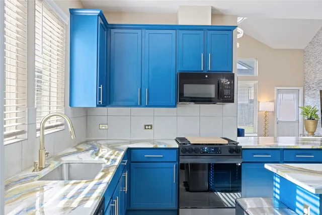 a kitchen with granite countertop wooden cabinets and a stove top oven
