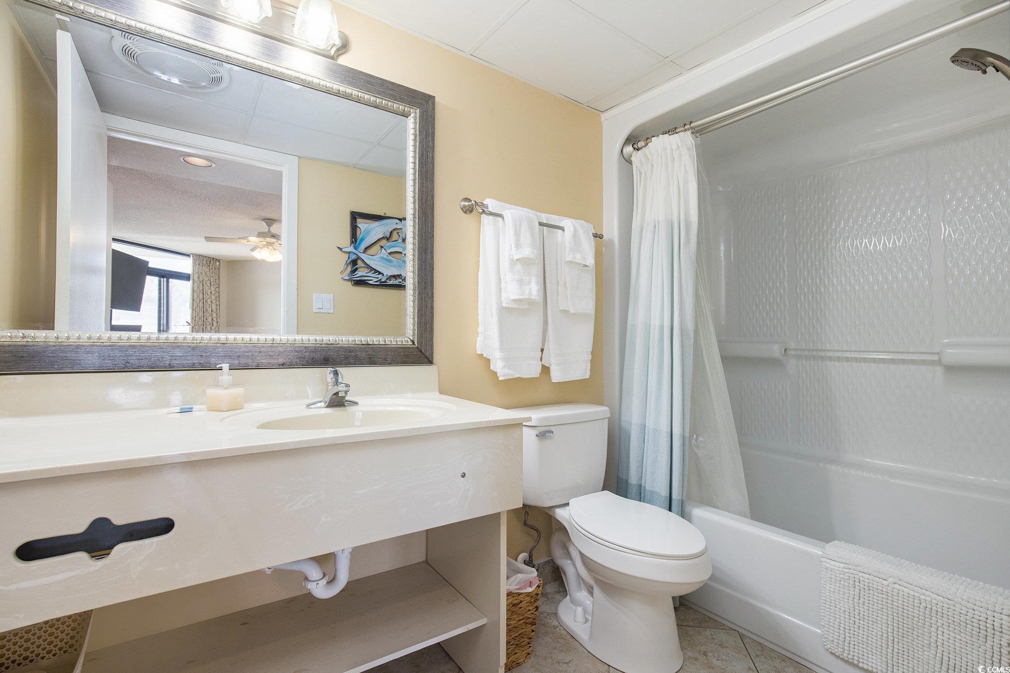 205 74th Avenue North, Unit 1810 Myrtle Beach, SC 29572 - Photo 28 of 37 Bathroom featuring tile patterned flooring, shower / bathtub combination with curtain, vanity, and ceiling fan