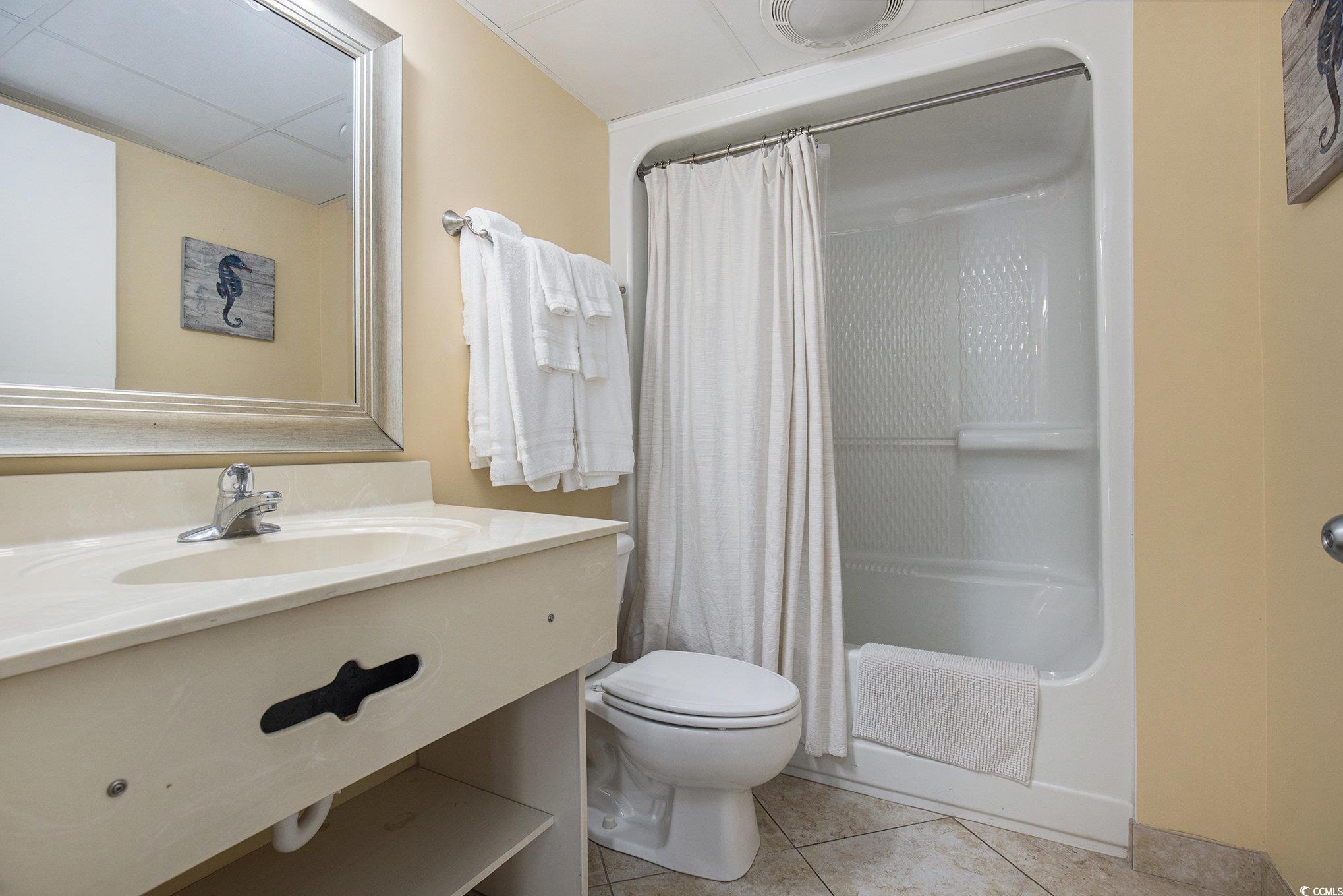 205 74th Avenue North, Unit 1810 Myrtle Beach, SC 29572 - Photo 30 of 37 Bathroom with light tile patterned flooring, vanity, and a shower with curtain