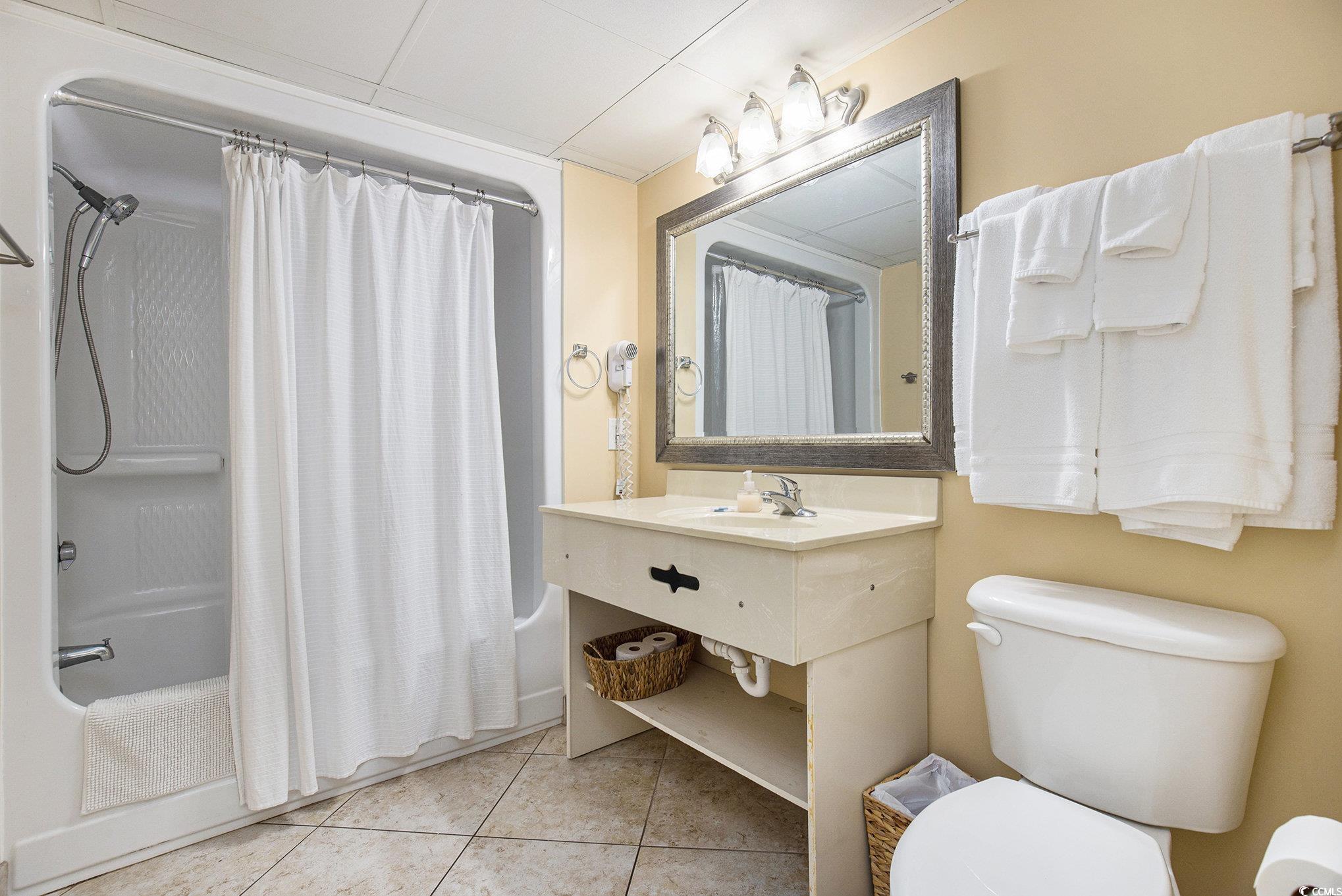 205 74th Avenue North, Unit 1810 Myrtle Beach, SC 29572 - Photo 32 of 37 Bathroom featuring shower / tub combo, light tile patterned flooring, and vanity