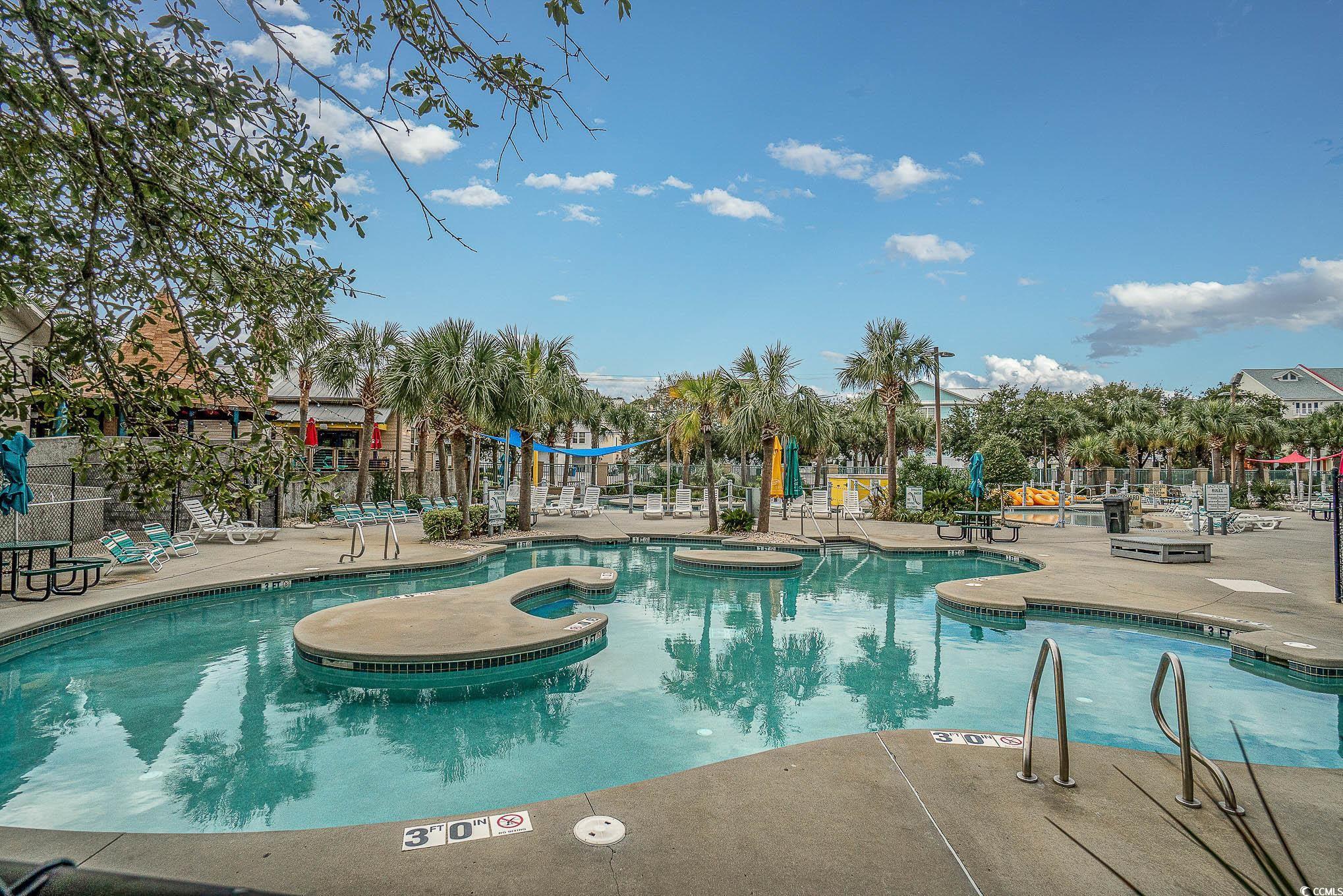 205 74th Avenue North, Unit 1810 Myrtle Beach, SC 29572 - Photo 4 of 37 Community pool with a patio