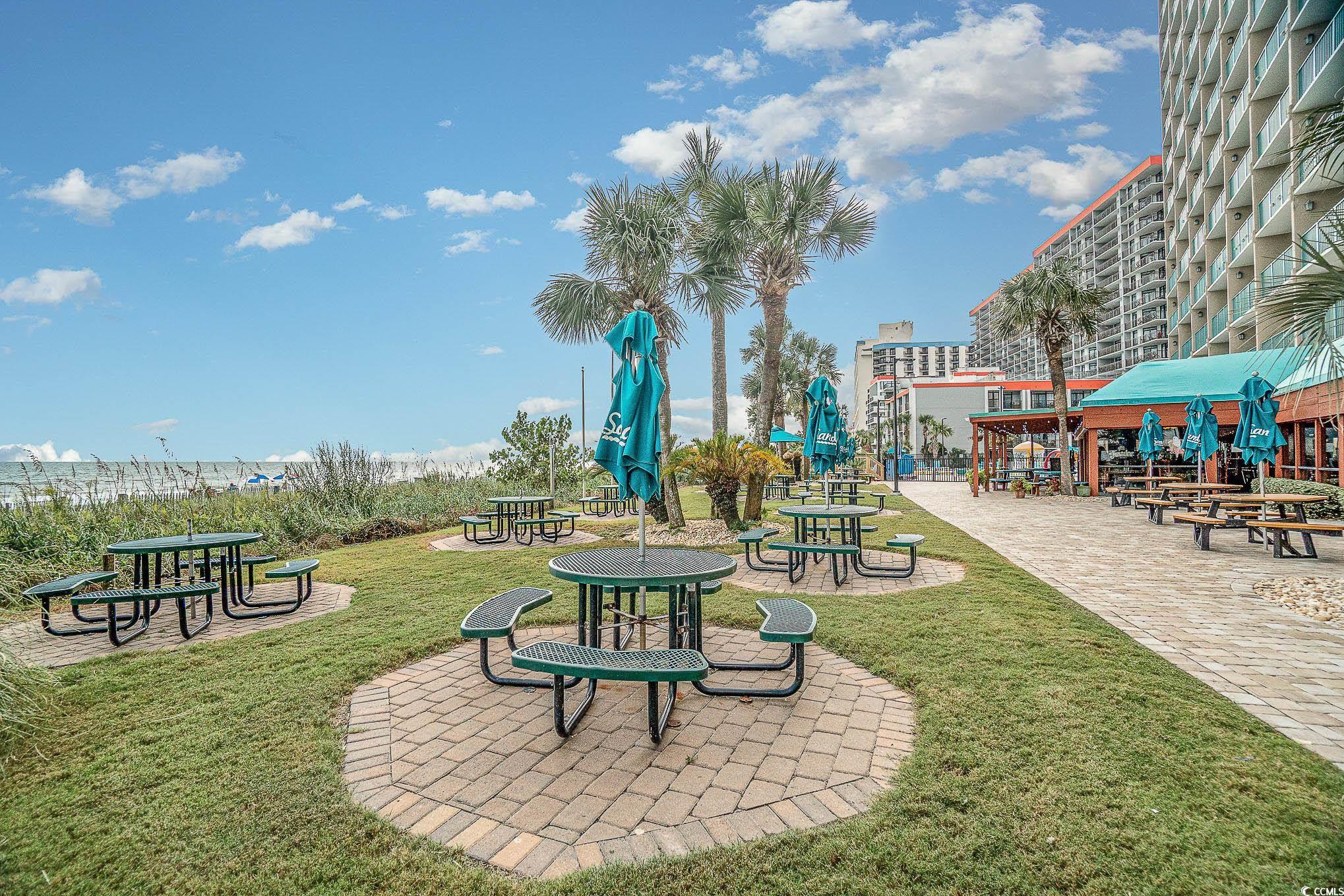 205 74th Avenue North, Unit 1810 Myrtle Beach, SC 29572 - Photo 7 of 37 Surrounding community featuring a yard and a patio
