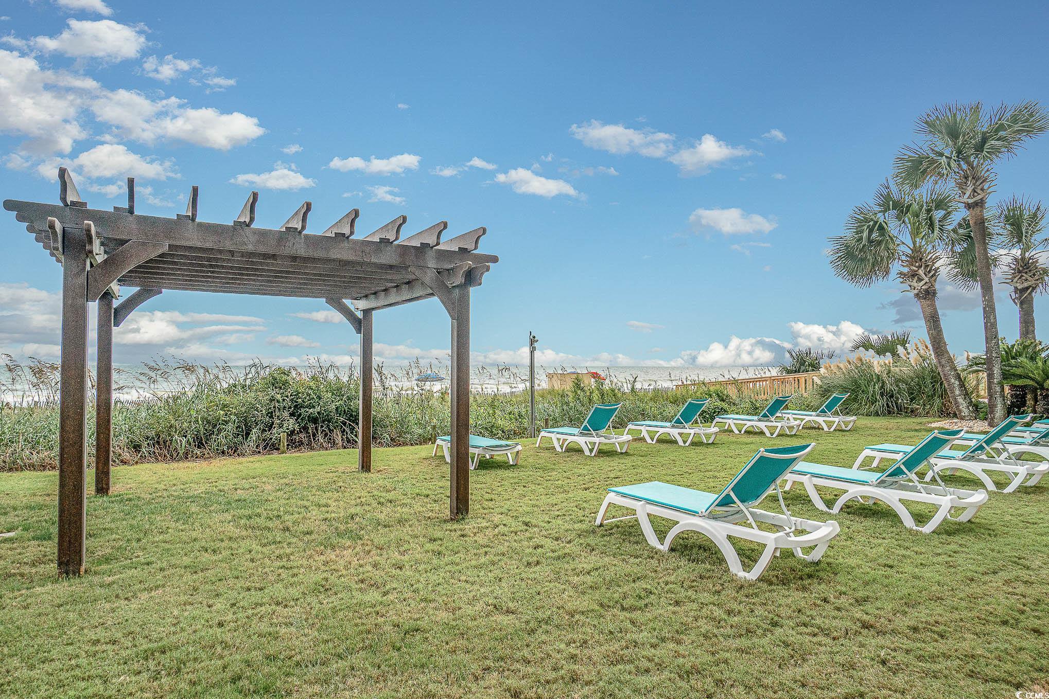 205 74th Avenue North, Unit 1810 Myrtle Beach, SC 29572 - Photo 8 of 37 View of grassy yard featuring a pergola