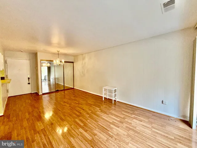 a view of an empty room and wooden floor
