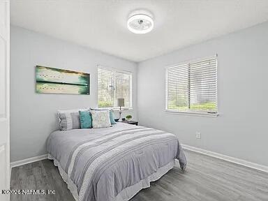 3270 Ricky Drive, Unit 1501 Jacksonville, FL 32223 - Photo 15 of 22 a bedroom with a bed and a painting on the wall