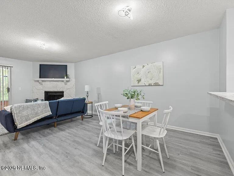 3270 Ricky Drive, Unit 1501 Jacksonville, FL 32223 - Photo 6 of 22 a dining room with furniture and wooden floor