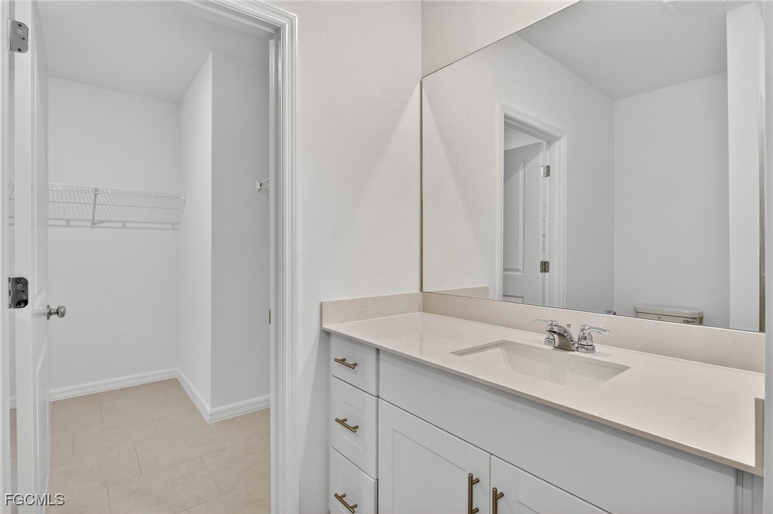 19778 Garden Ridge Lehigh Acres, FL 33936 - Photo 14 of 31 a bathroom with a sink and a mirror