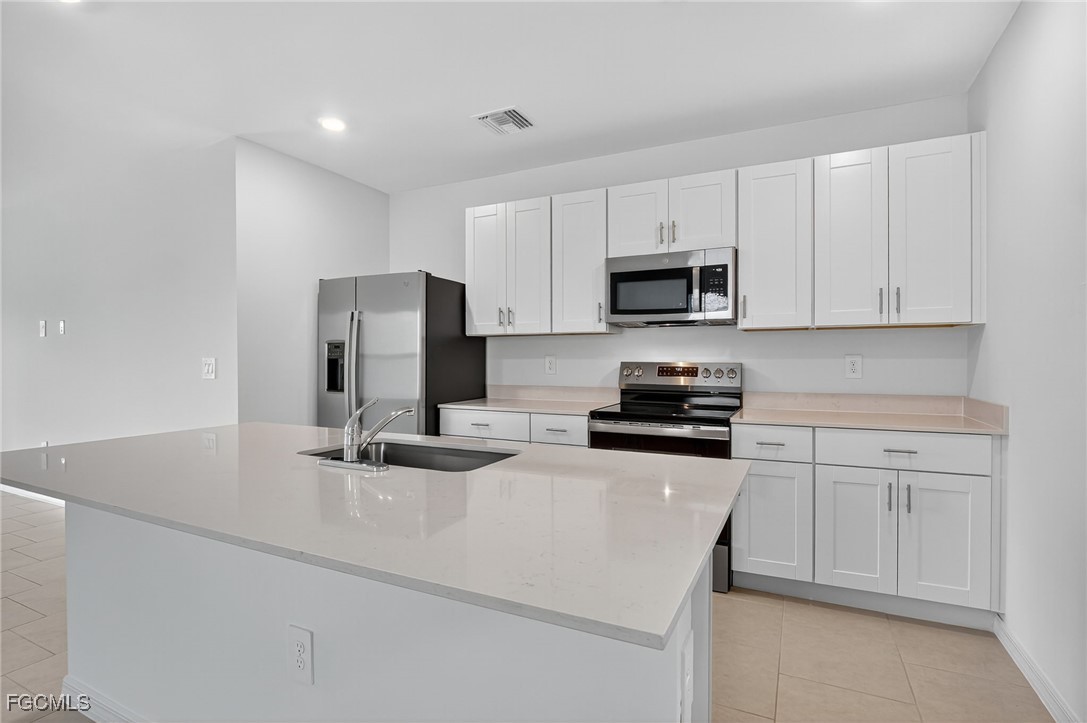 19778 Garden Ridge Lehigh Acres, FL 33936 - Photo 19 of 31 a kitchen with a sink and steel appliances