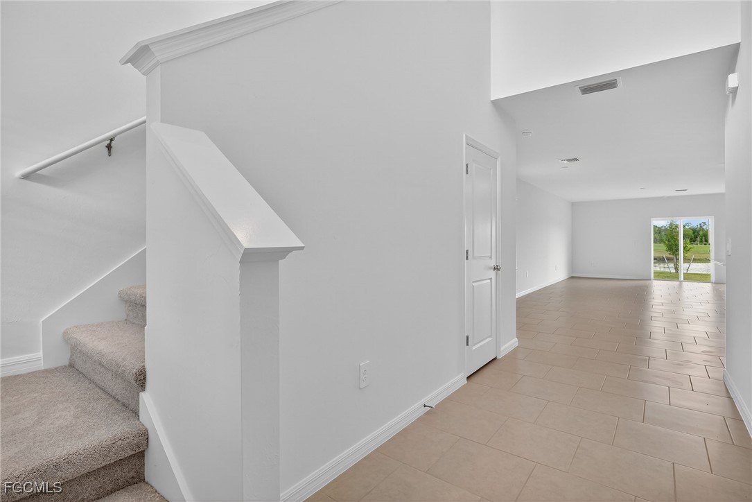 19778 Garden Ridge Lehigh Acres, FL 33936 - Photo 24 of 31 a view of a hallway with staircase