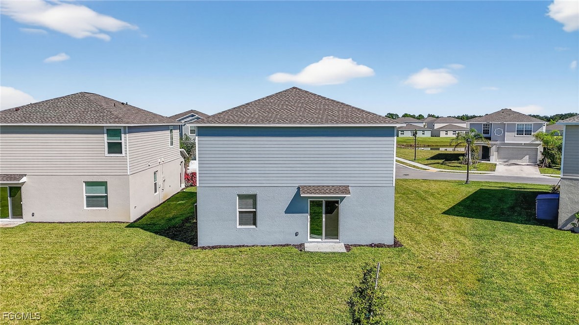 19778 Garden Ridge Lehigh Acres, FL 33936 - Photo 26 of 31 a front view of a house with a yard