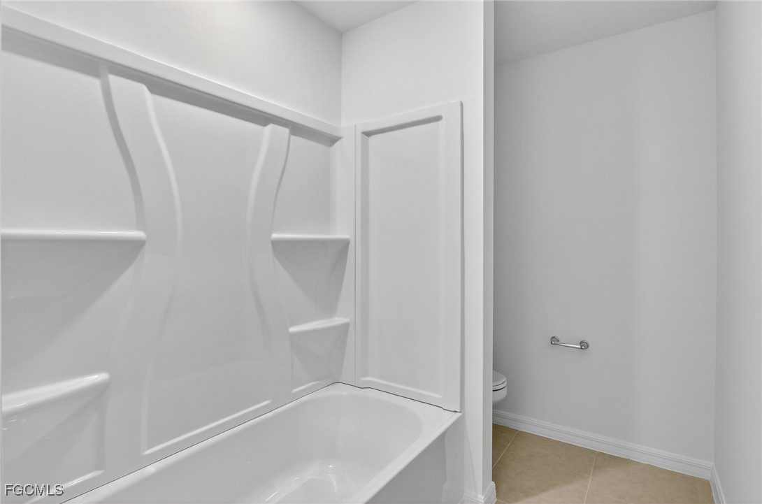 19778 Garden Ridge Lehigh Acres, FL 33936 - Photo 4 of 31 a view of walk in closet with empty racks