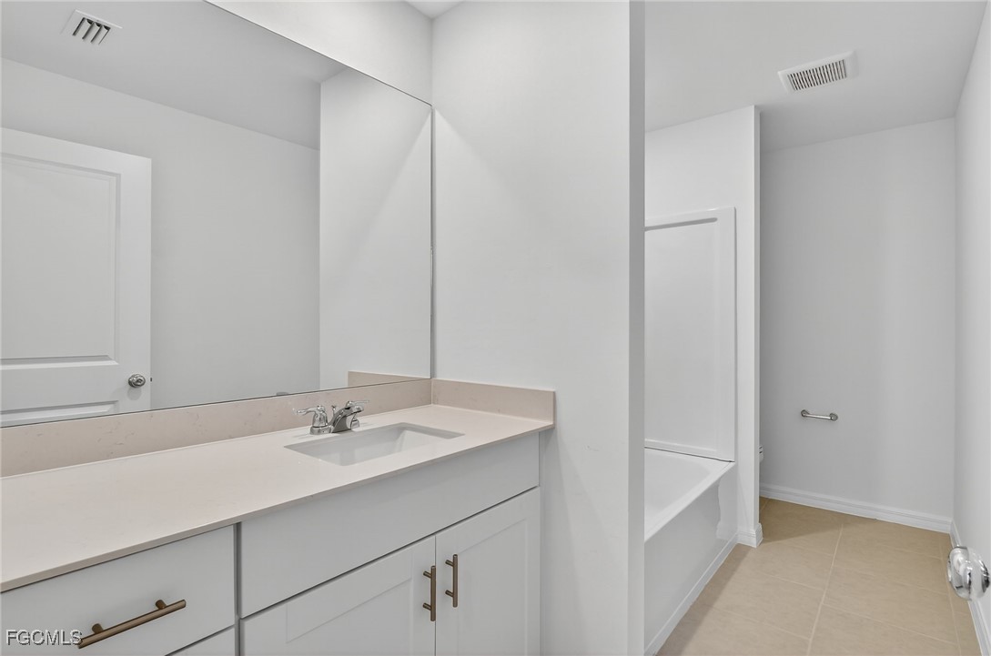 19778 Garden Ridge Lehigh Acres, FL 33936 - Photo 5 of 31 a bathroom with a sink and a mirror
