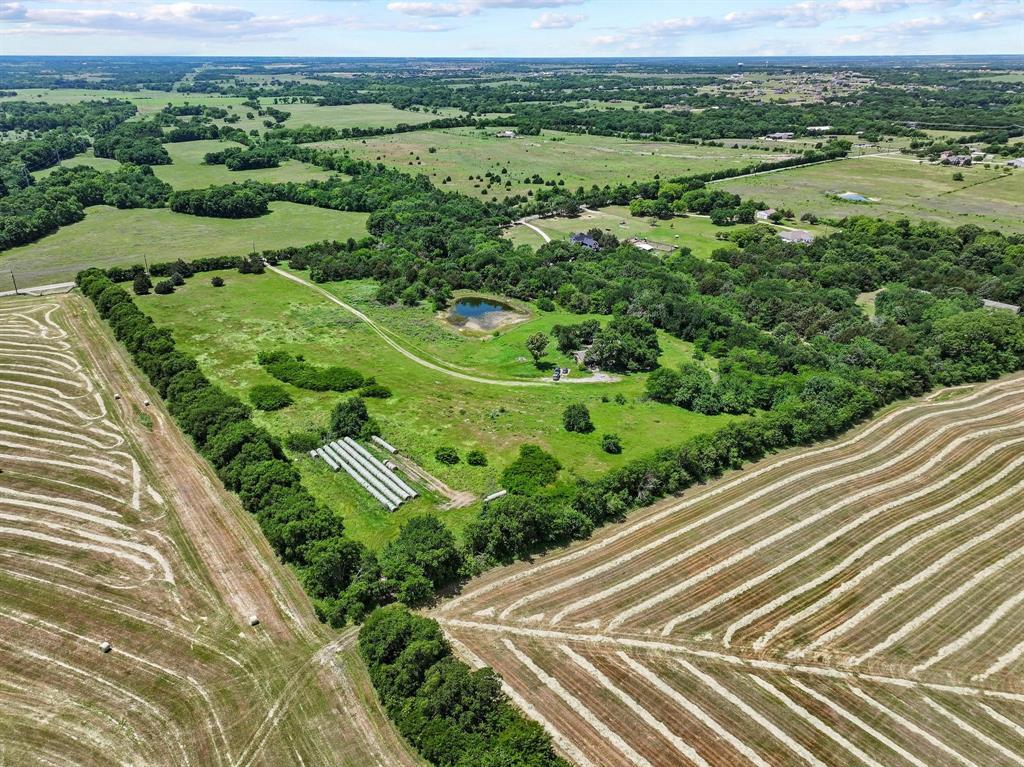 747 Vineyard Road Gunter, TX 75058 - Photo 11 of 32 a view of a green field with wooden floor
