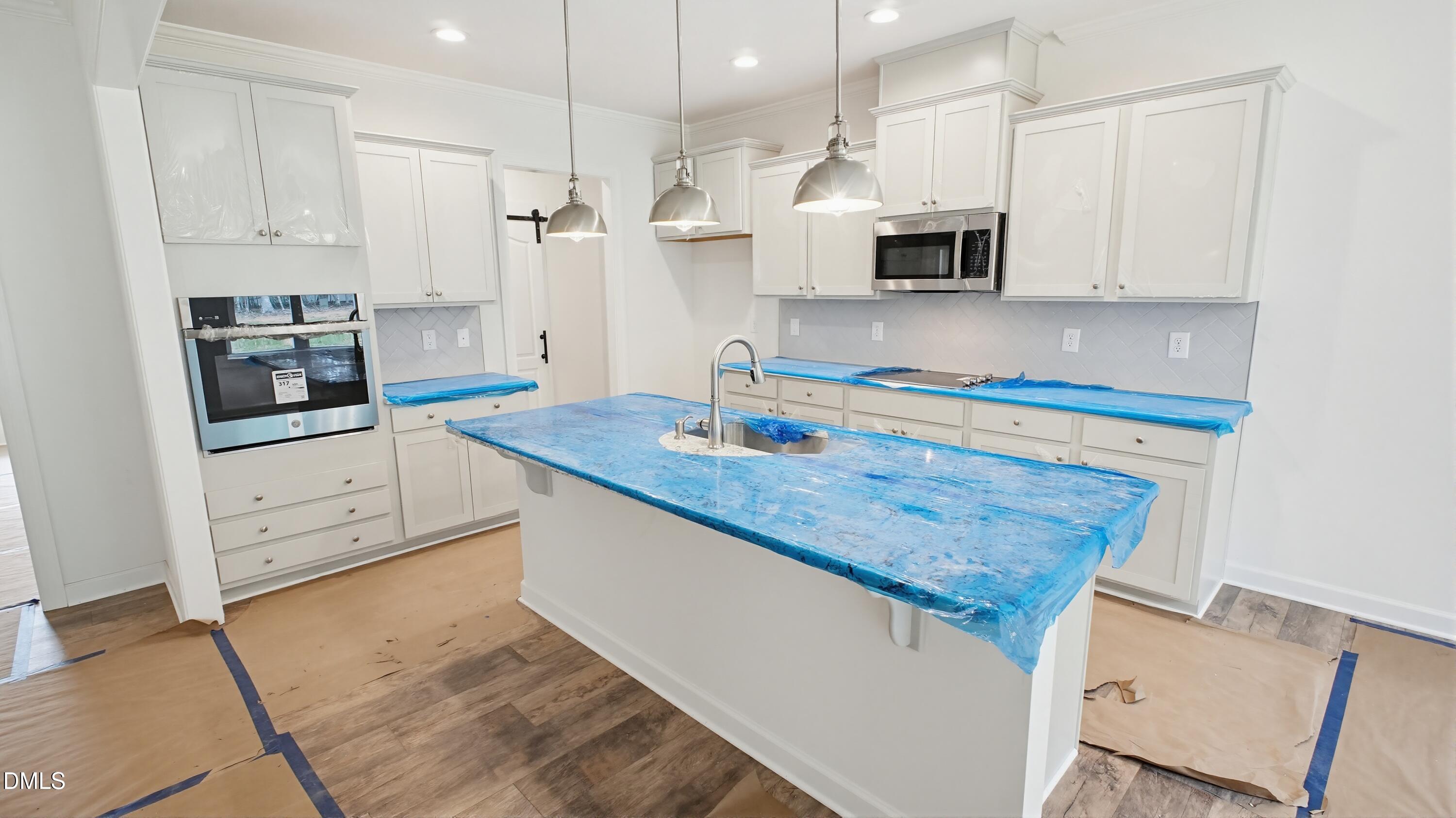 272 Seahawk Way Zebulon, NC 27597 - Photo 3 of 7 a kitchen with granite countertop white cabinets and stainless steel appliances