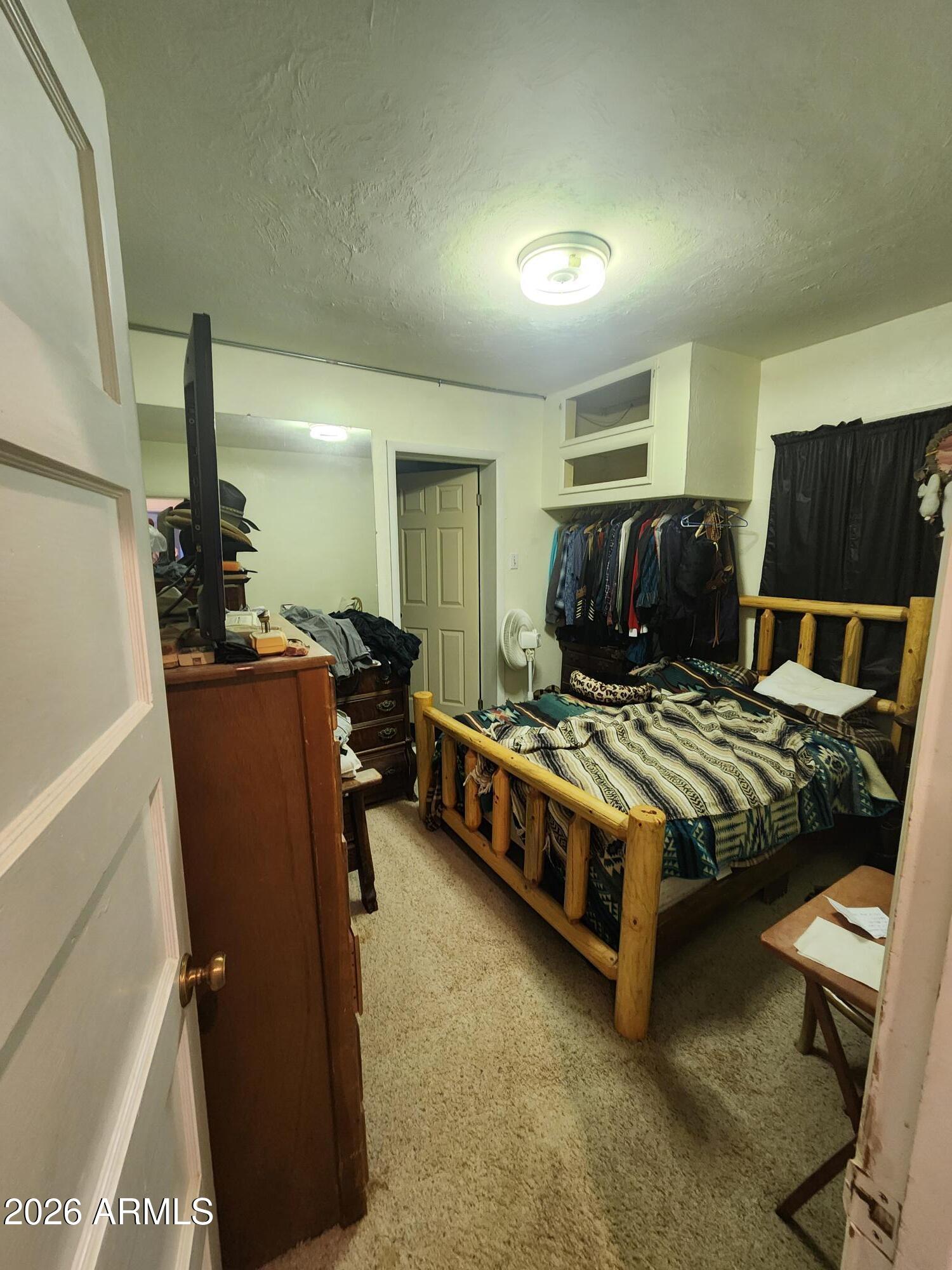 26115 Ghost Town Road Congress, AZ 85332 - Photo 15 of 64 a bedroom with a bed and wooden floor