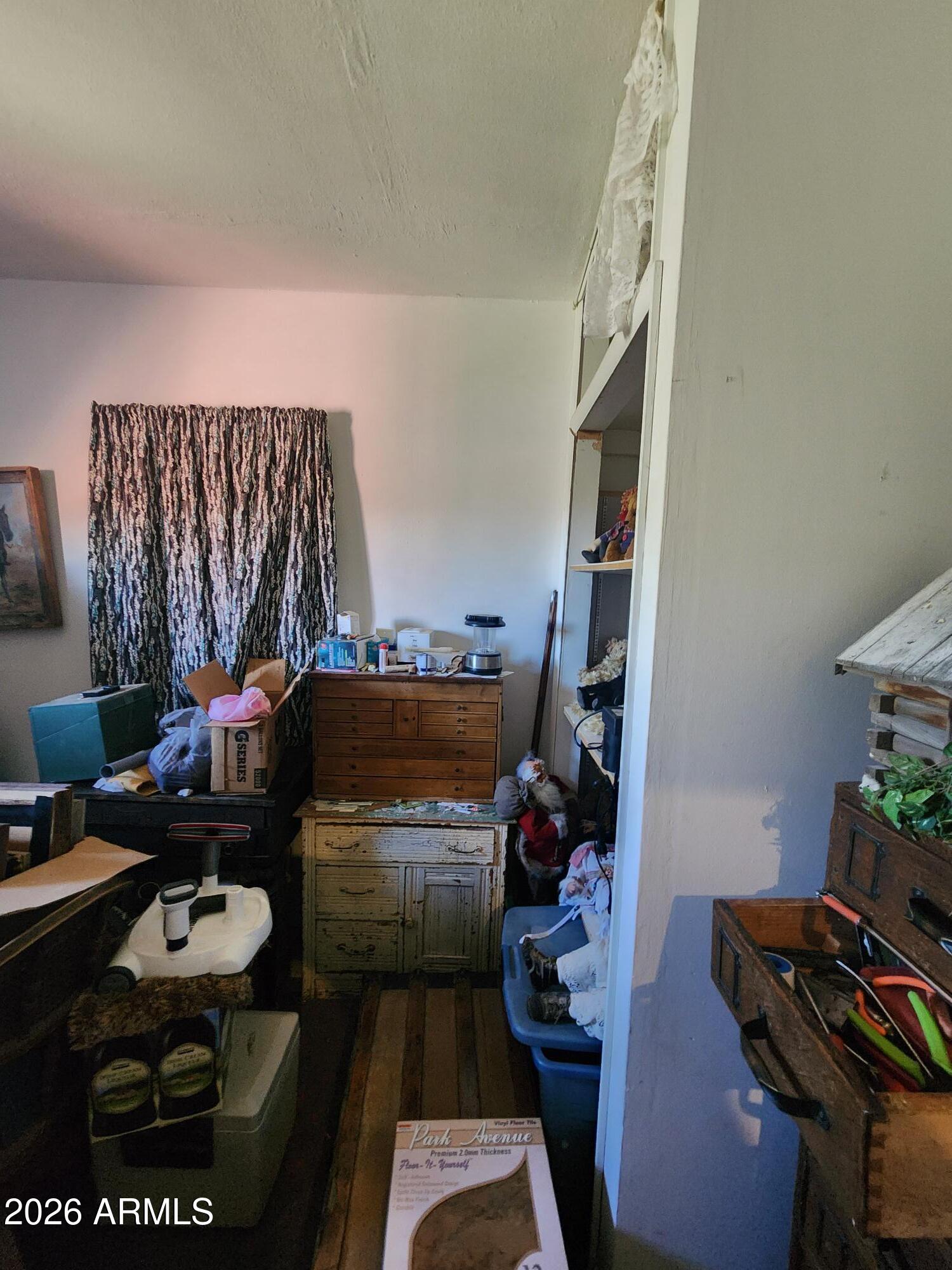 26115 Ghost Town Road Congress, AZ 85332 - Photo 19 of 64 a room with furniture and a book shelf