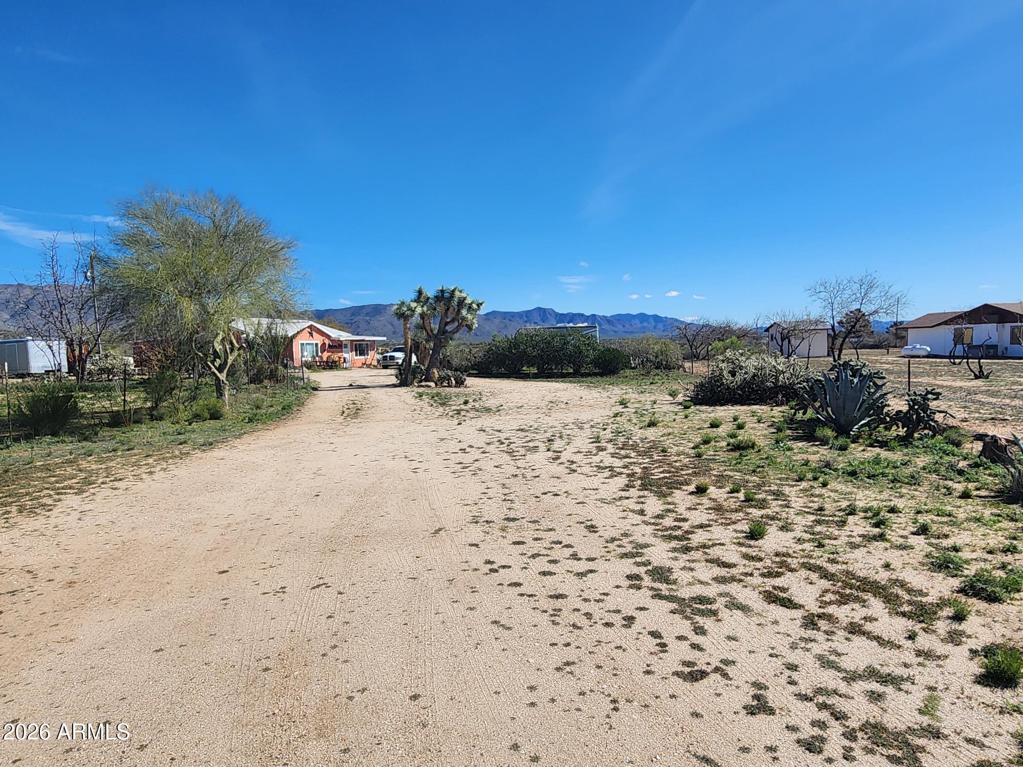 26115 Ghost Town Road Congress, AZ 85332 - Photo 24 of 64 a view of a yard with a tree