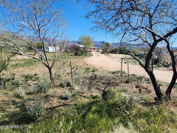 a view of a dirt road and building
