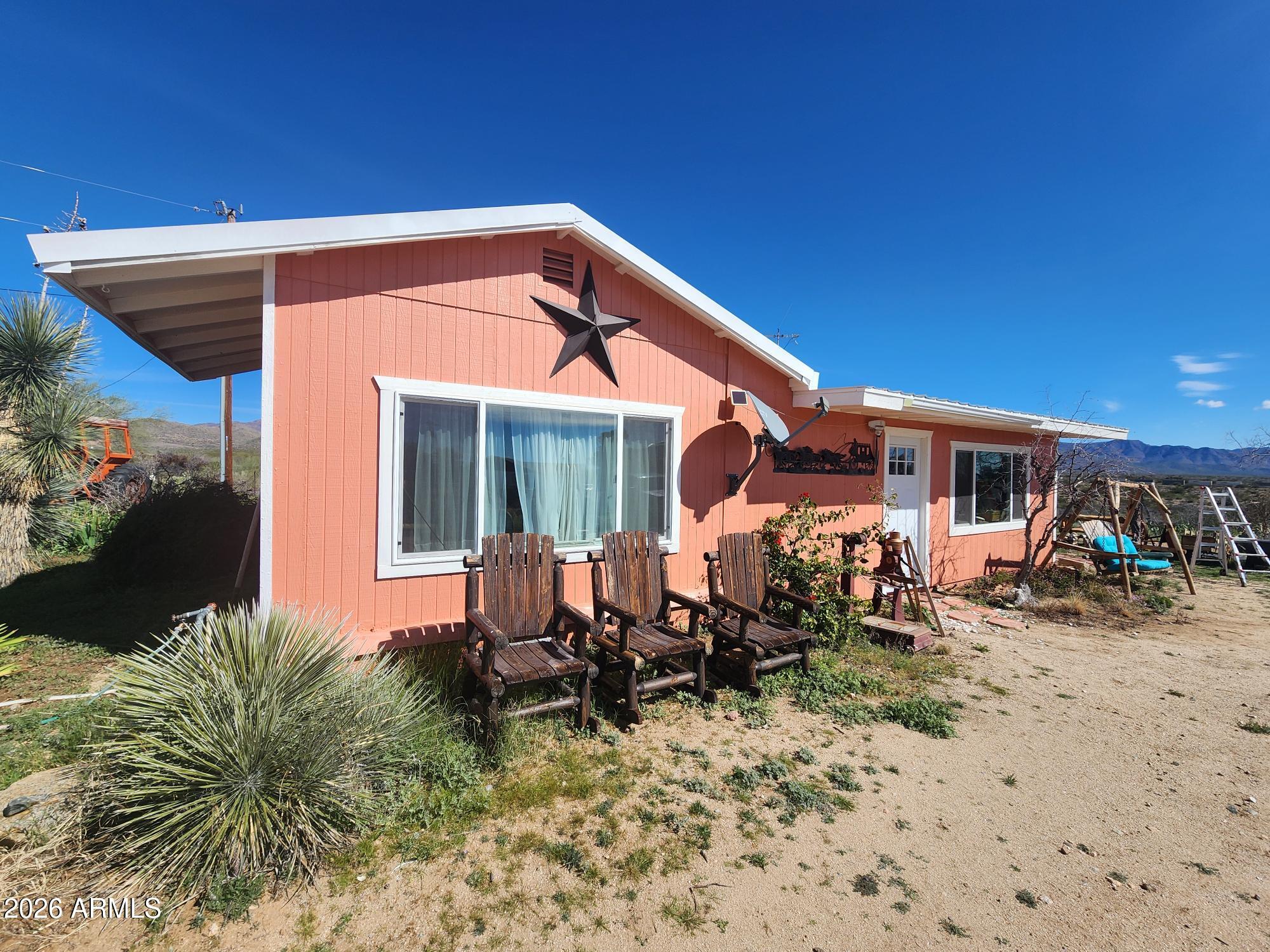 26115 Ghost Town Road Congress, AZ 85332 - Photo 34 of 64 a backyard of a house with seating space