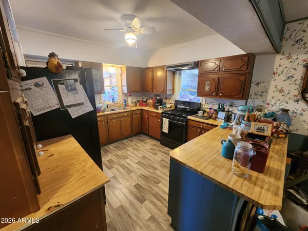 a kitchen with stainless steel appliances granite countertop a sink stove and wooden cabinets