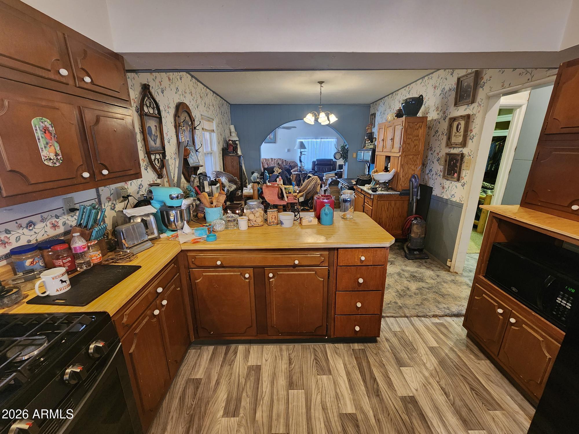 26115 Ghost Town Road Congress, AZ 85332 - Photo 8 of 64 a kitchen with stainless steel appliances granite countertop a sink stove and wooden cabinets