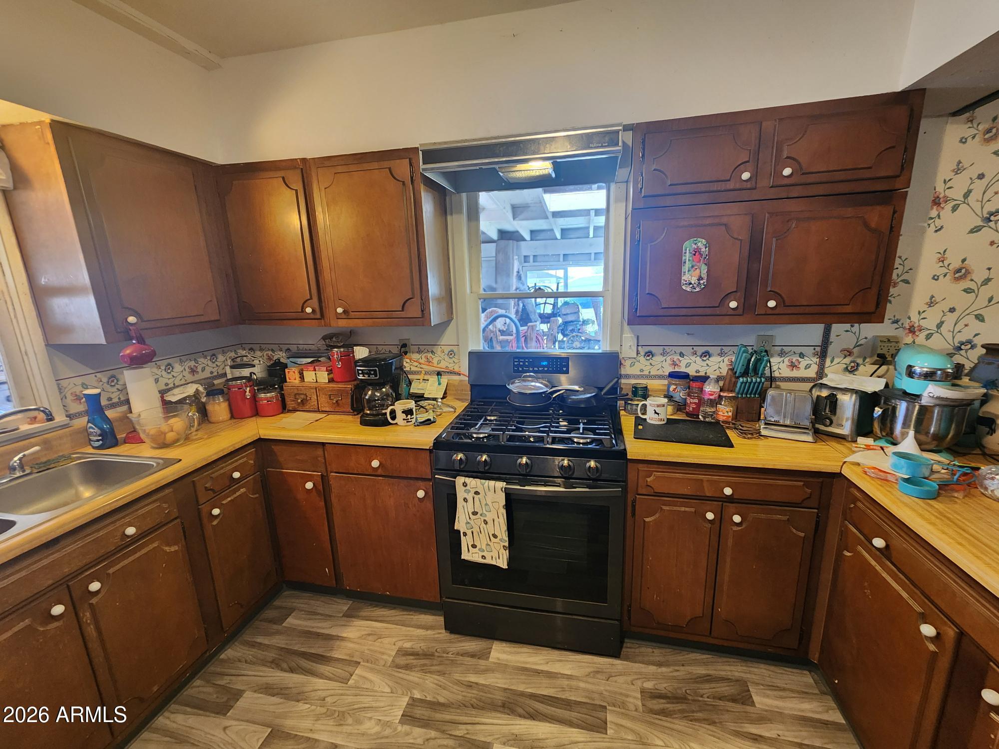 26115 Ghost Town Road Congress, AZ 85332 - Photo 9 of 64 a kitchen with stainless steel appliances granite countertop a stove a sink and a microwave